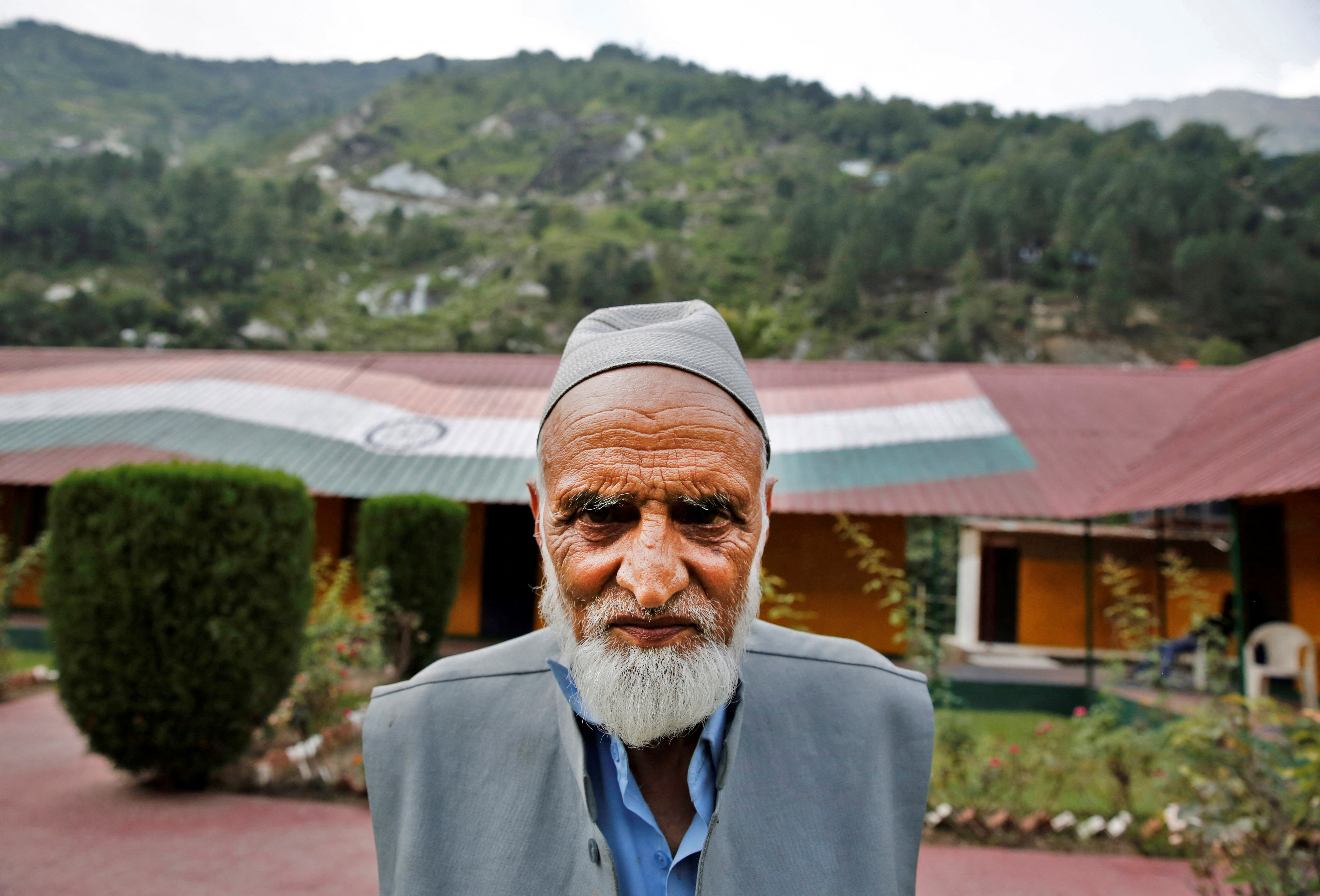 Abdul Rashid Khokhar poses for a photograph near the Line of Control between India and Pakistan in Teetwal