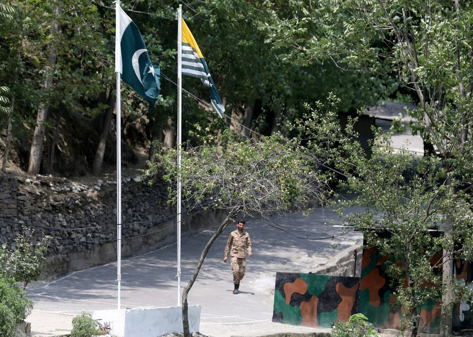 A Pakistani trooper walks up to his a bunker in Pakistan administered Kashmir as seen from the Indian administered Kashmir in Teetwal in north Kashmir's Kupwara district August 8, 2022. REUTERS