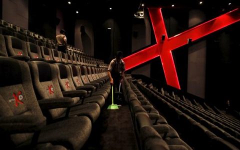 an employee at a cinemaxx theatre cleans up between screenings photo reuters