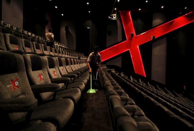 an employee at a cinemaxx theatre cleans up between screenings photo reuters